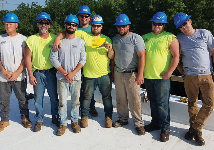 Employees of McDowall Co., Waite Park, Minn., show their support of National Roofing Week.
